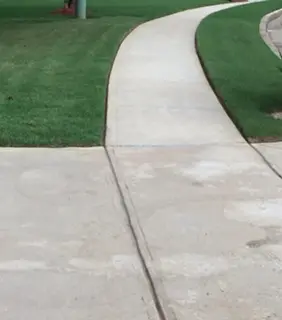 Freshly edged lawn along a curved sidewalk